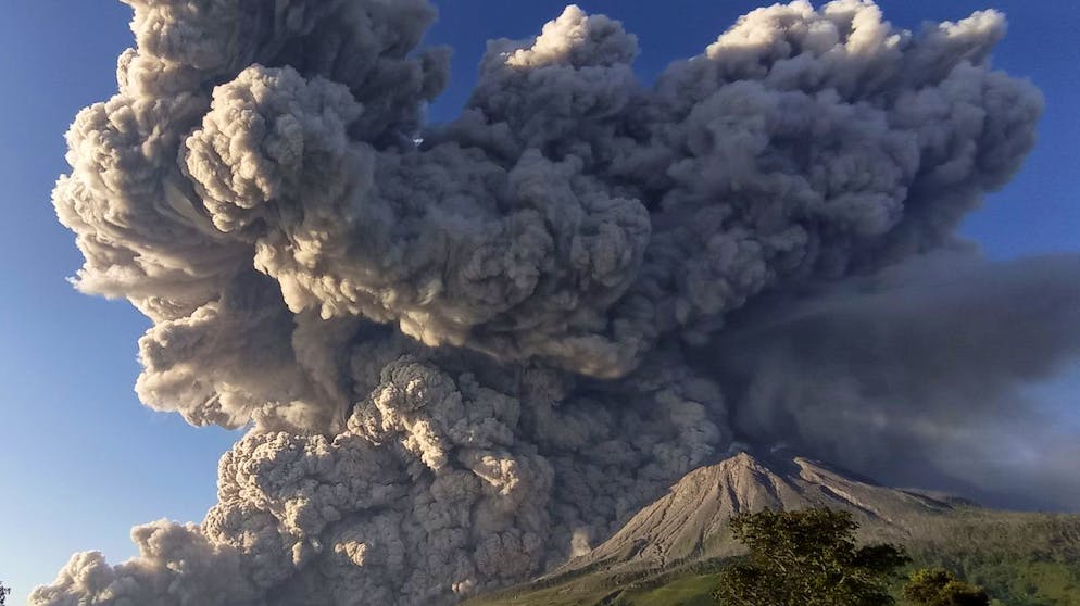 CORRECTS DATE - Mount Sinabung spews volcanic material during an eruption in Karo, North Sumatra, Indonesia, Tuesday, March 2, 2021. The 2,600-metre (8,530-feet) volcano erupted Tuesday, sending volcanic materials a few thousand meters into the sky and depositing ash on nearby villages. (AP Photo/Sastrawan Ginting)