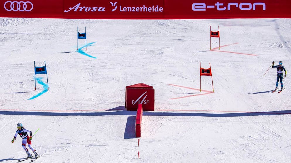 Camille Rast of Switzerland, left, in action against Moa Bostroem Mussener of Sweden, right, during the 1/4 final of the Mixed Team Parallel race at the FIS Alpine Skiing World Cup finals, in Parpan-Lenzerheide, Switzerland, Friday, March 19, 2021. (KEYSTONE/Jean-Christophe Bott)