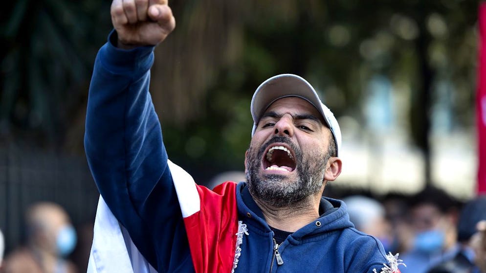 epa09084279 An anti-government protester shouts slogans during a protest against the power cuts, the high cost of living and the low purchasing power of the Lebanese pound, in front of the Lebanese Ministry of Energy and Water in Beirut, Lebanon, 19 March 2021. Many Lebanese have recently expressed anger at the growing economic and currency crisis, as well as the failure of political leaders to form a government after months of deadlock. EPA/WAEL HAMZEH