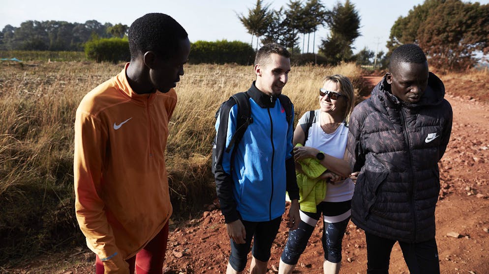 ITEN, KENYA - FEBRUARY 21, 2021. Julien Wanders, 24, is a Swiss long-distance runner. He currently has the European record for the half marathon with a time of 59:13, which was set at the Ras Al Khaimah Half Marathon in 2019 and the European record for the 10K run, with a time of 27:13 set in Valencia on January 12, 2020. He lives and trains in Iten, Kenya, with a group of pan-african runners. He is pictured here with his team mates Amos Kimutai, left, and Aras Kaya, right, and his mother Bénédicte Moreau Wanders, center, after a long run. CREDIT: ELISABETH REAL
