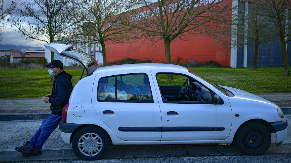 Javier Irure, 65, leans on his car which is now his home, in Pamplona, northern Spain, Friday, March 19, 2021. Javier Irure had only one possible roof to put over his head when the 65-year-old Spaniard was evicted after the economic slowdown caused by the coronavirus pandemic destroyed his financial stability. Irure said from his old Renault Clio compact that has provided him with shelter for the past three months. (AP Photo/Alvaro Barrientos)