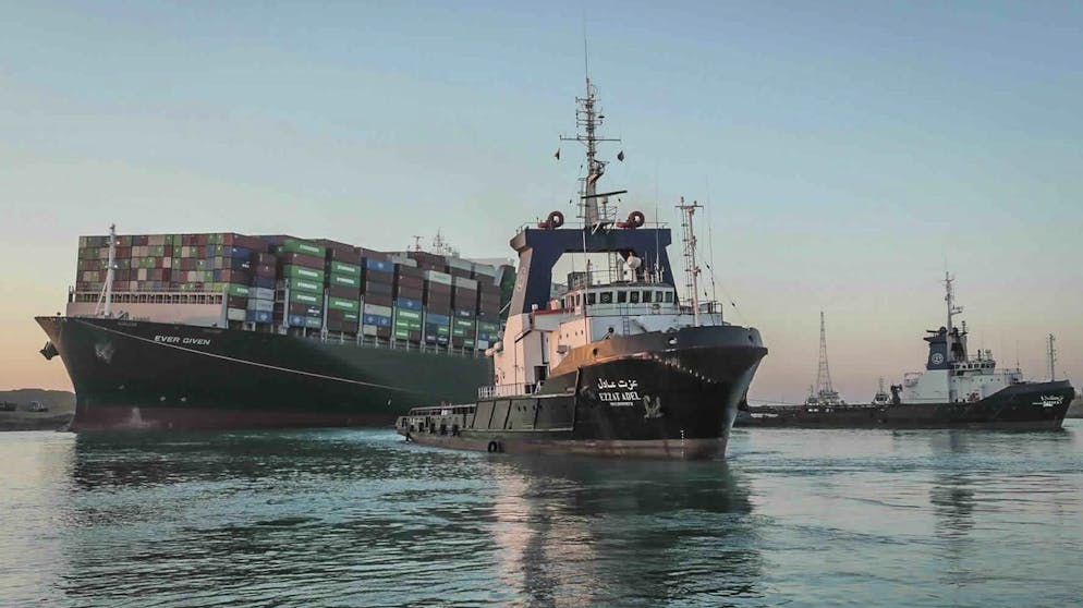 In this photo released by Suez Canal Authority, the Ever Given, a Panama-flagged cargo ship is pulled by one of the Suez Canal tugboats, in the Suez Canal, Egypt, Monday, March 29, 2021. Engineers on Monday
