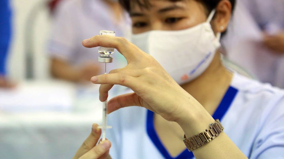 epa09108315 A nurse prepares a shot of COVID-19 vaccine developed by AstraZeneca ('Vaxzevria') at the Hanoi police hospital, in Hanoi, Vietnam 31 March 2021. 36 officials from Hanoi Immigration Department have received COVID-19 vaccine on 31 March 2021. EPA/LUONG THAI LINH