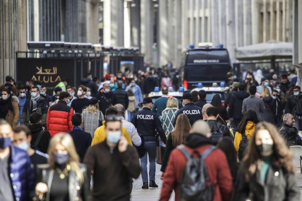 Police and Carabinieri, patrol along Corso Vittorio Emanuele II, in Milan, Italy, Saturday, Feb. 27, 2021. (AP Photo/Luca Bruno)