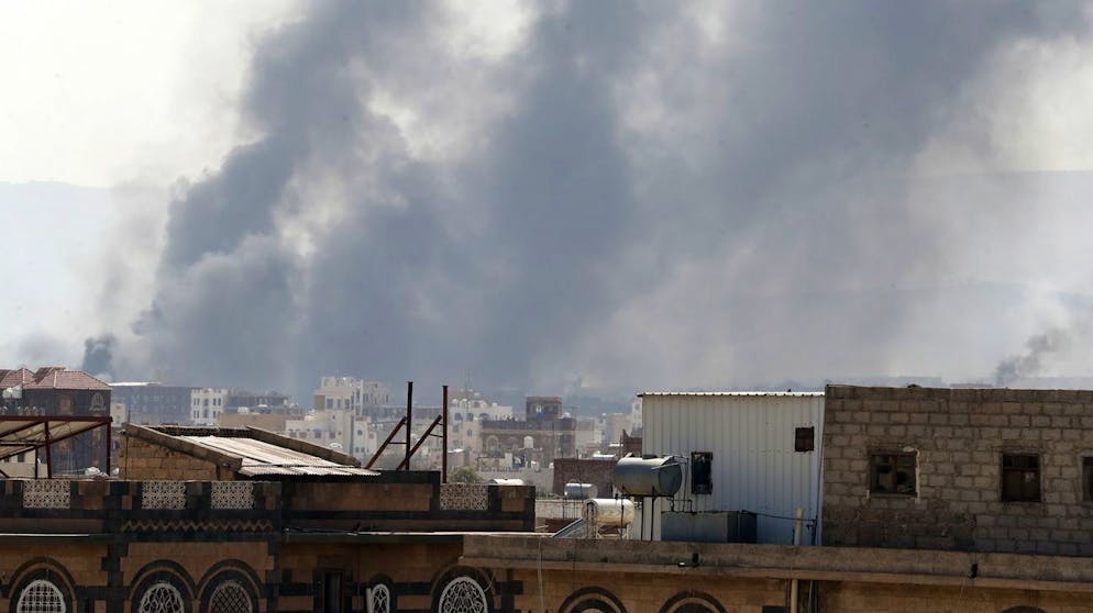 epa09058916 Smoke billows above a neighborhood following Saudi-led airstrikes targeting positions in Sana'a, Yemen, 07 March 2021. The Saudi-led coalition's warplanes waged a series of airstrikes on positions across Yemen, including the capital Sana'a. EPA/YAHYA ARHAB