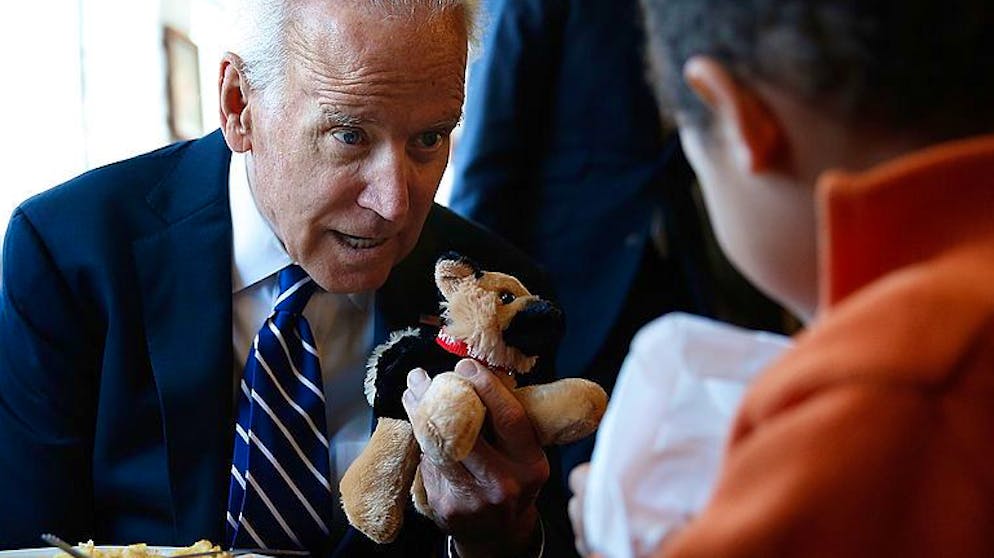 WASHINGTON, DC - MARCH 26: U.S. Vice President Joe Biden gives a young boy a stuffed version of Biden's dog, Champ, while visiting a diner March 26, 2014 in Washington, DC. Biden visited the Florida Avenue Grill to highlight the administration's efforts to raise the national minimum wage to $10.10 an hour. (Photo by Win McNamee/Getty Images)