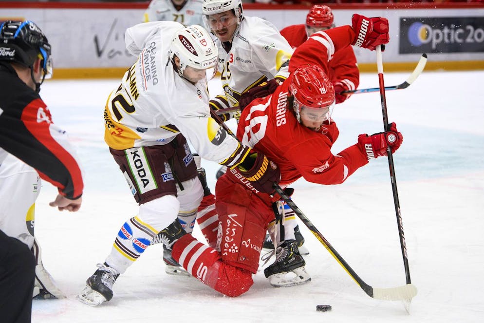 Le defenseur genevois Michael Voellmin, gauche, et le defenseur genevois Roger Karrer, centre, luttent pour le puck avec l'attaquant lausannois Josh Jooris, droite, lors du match a huis clos du championnat suisse de hockey sur glace de National League entre le Lausanne HC, LHC, et Geneve-Servette HC, GSHC, ce jeudi 1 avril 2021 a la patinoire de la Vaudoise Arena a Lausanne. (KEYSTONE/Laurent Gillieron)