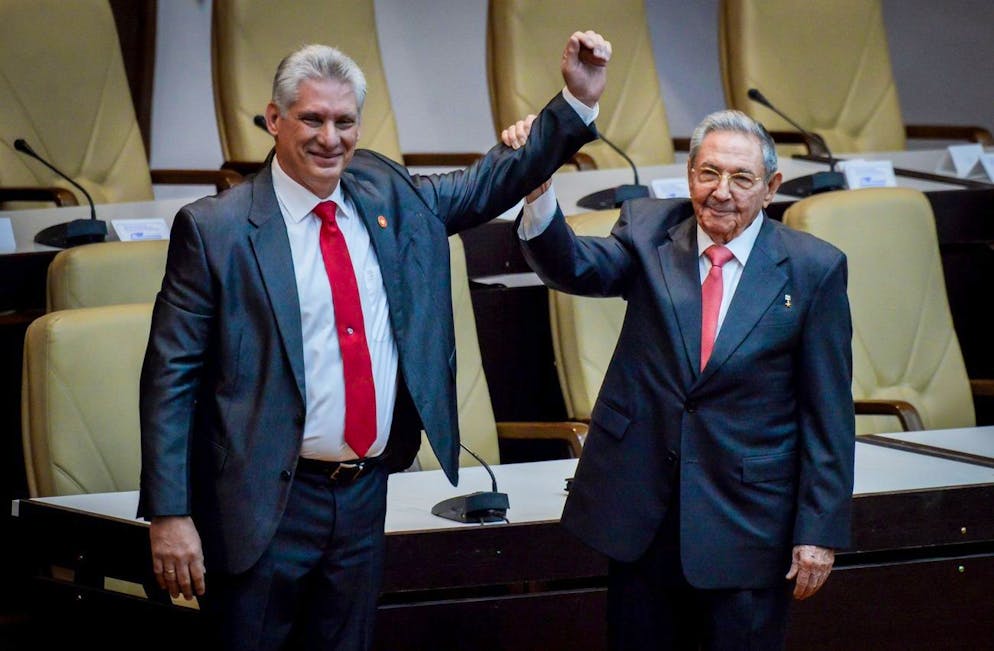epa06680176 First Secretary of Cuba's Communist Party and now former president Raul Castro (R) holds the arm of new president Miguel Diaz-Canel (L) in Havana, Cuba, 19 April 2018. Diaz-Canel, former first vice president of the Government, was appointed President of Cuba by the National Assembly to substitute Raul Castro, who retires after 12 years in power. The new leader assured that the island's foreign policy will remain unalterable and that the country will not negotiate its principles. EPA/Adalberto Roque / POOL