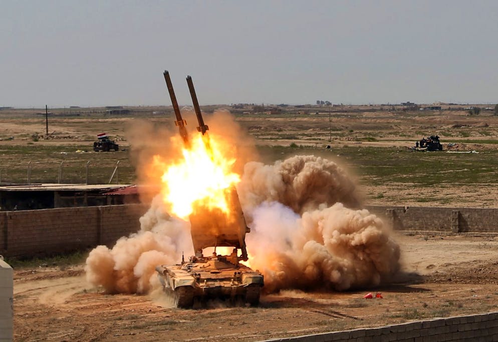 FILE - In this Sunday, March 31, 2015 file photo, Iraqi security forces launch rockets against Islamic State extremist positions in Tikrit, 80 miles (130 kilometers) north of Baghdad, Iraq. Iraqi forces battled Islamic State militants holed up in downtown Tikrit, going house to house Tuesday in search of snipers and booby traps, and the prime minister announced security forces had reached the city's center. (AP Photo/Khalid Mohammed, File)