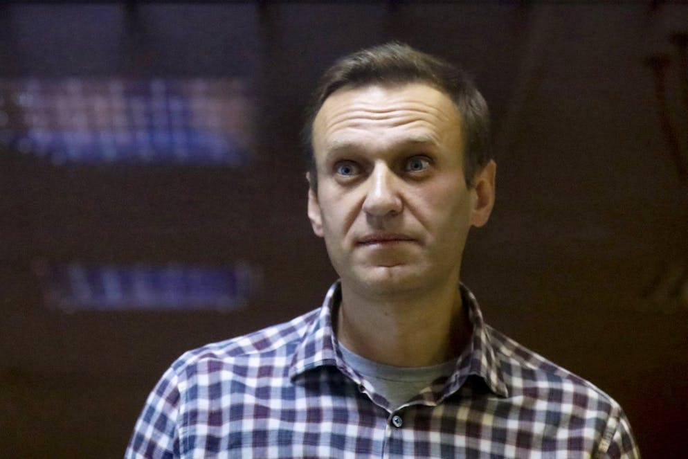 FILE - In this Saturday, Feb. 20, 2021 file photo, Russian opposition leader Alexei Navalny stands in a cage in the Babuskinsky District Court in Moscow, Russia. Imprisoned Russian opposition leader Alexei Navalny, who has been on hunger strike since March 31, described threats to force-feed him, using