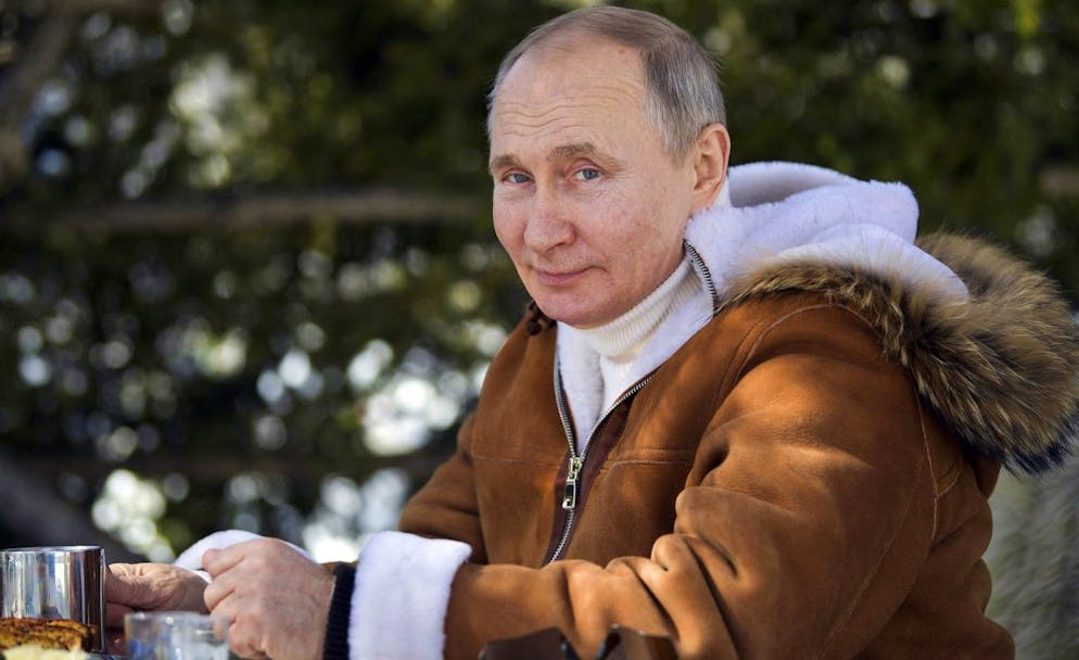 In this photo made available on Sunday, March 21, 2021, Russian President Vladimir Putin looks at a photographer in a taiga forest in Russia's Siberian region. Putin and Russia Defense Minister Sergei Shoigu are spending the weekend in Siberia, said Kremlin spokesman Dmitry Peskov. (Alexei Druzhinin, Sputnik, Kremlin Pool Photo via AP)