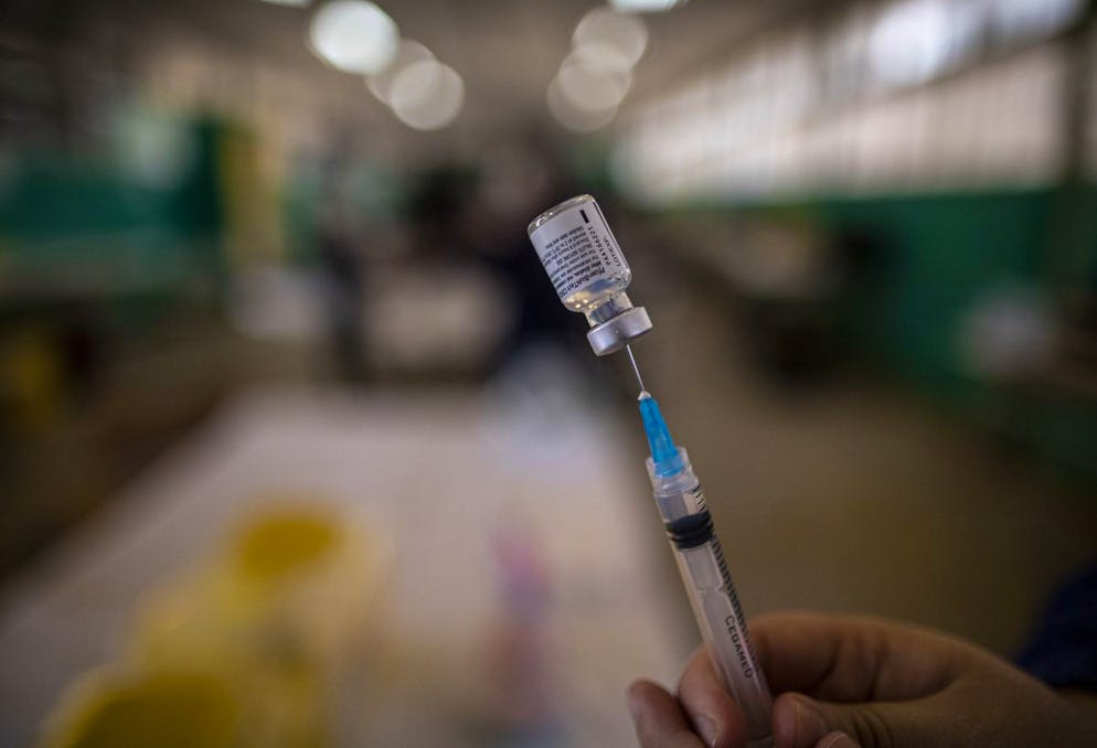 A health worker prepares a dose of the Pfizer vaccine for COVID-19 at the Carolina Vergara school in Santiago, Chile, Wednesday, April 14, 2021. (AP Photo/Esteban Felix)