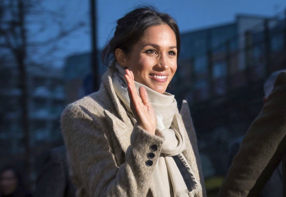 Meghan Markle waves to the crowd as she leaves after a visit with Britain's Prince Harry to the Reprezent 107.3 FM radio station in Brixton, south London, Tuesday, Jan. 9, 2018. The royal couple visited Tuesday to see the station's work supporting young people through creative training in radio and broadcasting, and to learn more about their model of using music, radio and media for social impact. (AP Photo/ Dominic Lipinski, Pool)