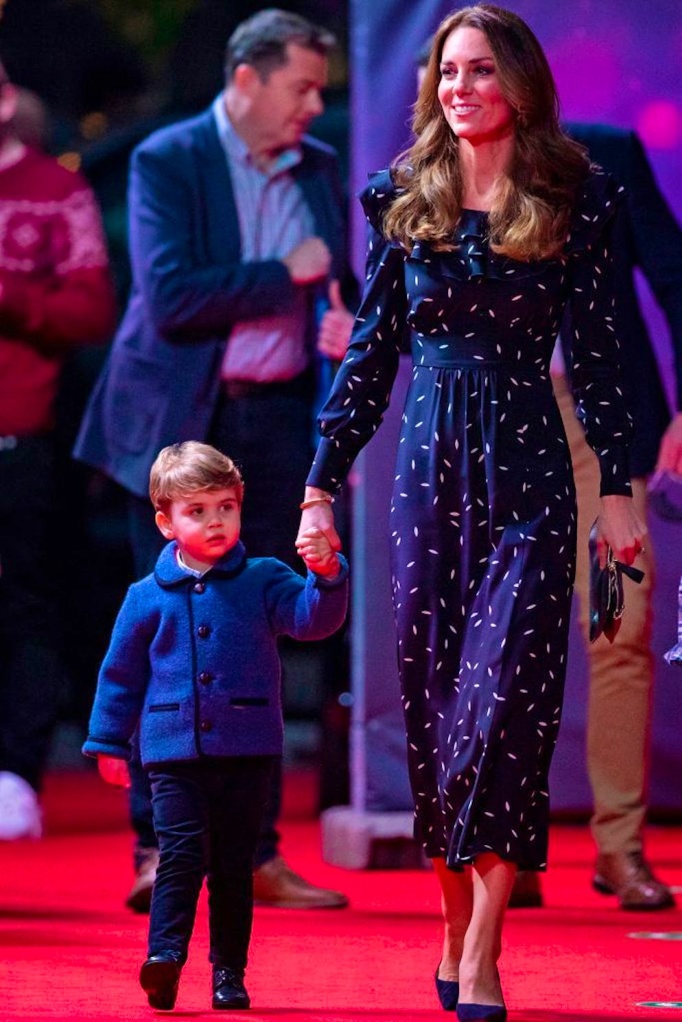 Britain's Catherine, Duchess of Cambridge, holds the hand of her son, Britain's Prince Louis of Cambridge as they attend a special pantomime performance of The National Lotterys Pantoland at London's Palladium Theatre in London on December 11, 2020, to thank key workers and their families for their efforts throughout the pandemic. (Photo by Aaron Chown / POOL / AFP) (Photo by AARON CHOWN/POOL/AFP via Getty Images)