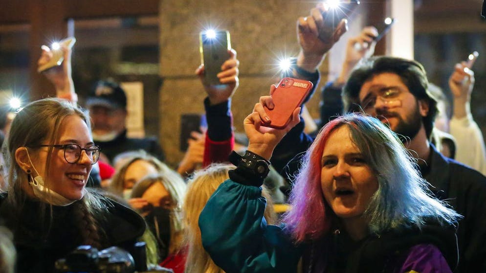 People shine the lights of their mobile phones during the opposition rally in support of jailed opposition leader Alexei Navalny in Moscow, Russia, Wednesday, April 21, 2021. Police across Russia have arrested more than 180 people in connection with demonstrations in support of imprisoned opposition leader Alexei Navalny, according to a human rights group. (AP Photo/Alexander Zemlianichenko)