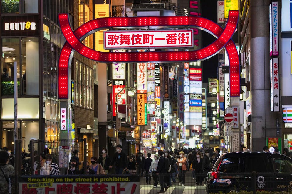 People walk through the famed Shinjuku street lined with restaurants and bars in Tokyo on Friday, April 23, 2021. Japanese Prime Minister Yoshihide Suga announced Friday that several prefectures including Tokyo for the third time will have the state of emergency, starting Sunday. (AP Photo/Hiro Komae)