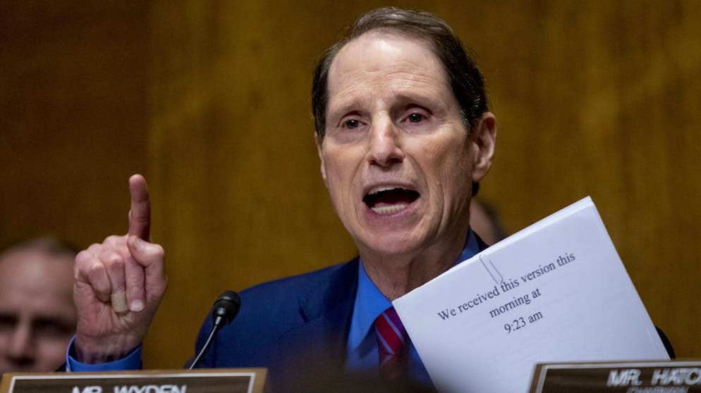 Sen. Ron Wyden, D-Ore., holds up the current version of the Graham-Cassidy healthcare proposal as he speaks at a Senate Finance Committee hearing to consider the proposal, on Capitol Hill, Monday, Sept. 25, 2017, in Washington. (AP Photo/Andrew Harnik)