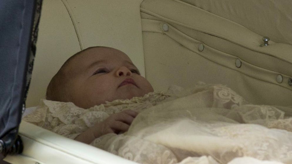 Britain's Princess Charlotte is pushed in a pram by her mother Kate the Duchess of Cambridge as they arrive for Charlotte's Christening at St. Mary Magdalene Church in Sandringham, England, Sunday, July 5, 2015. (AP Photo/Matt Dunham, Pool)