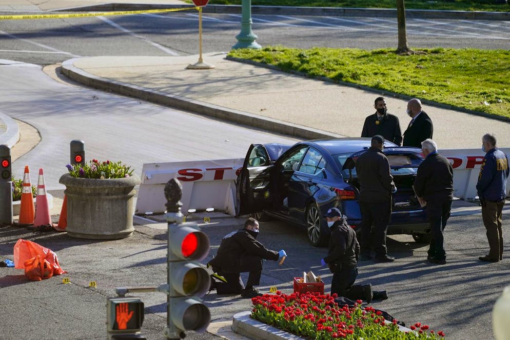 Authorities investigate the scene after a man rammed a car into two officers at the barricade on Capitol Hill in Washington, Friday, April 2, 2021. (AP Photo/Alex Brandon)
