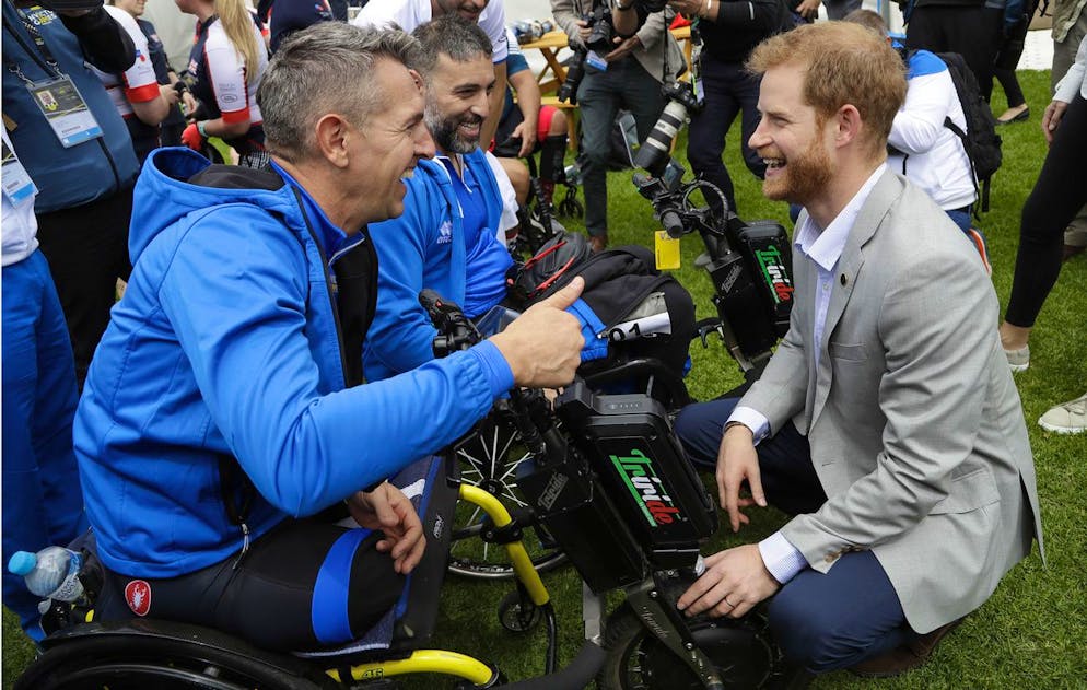 Britain's Prince Harry meets Italian competitors as he attends the Invictus Games cycling competition at the Royal Botanic Garden in Sydney, Australia, Sunday, Oct. 21, 2018. Prince Harry and his wife Meghan are on day six of their 16-day tour of Australia and the South Pacific. (AP Photo/Kirsty Wigglesworth)