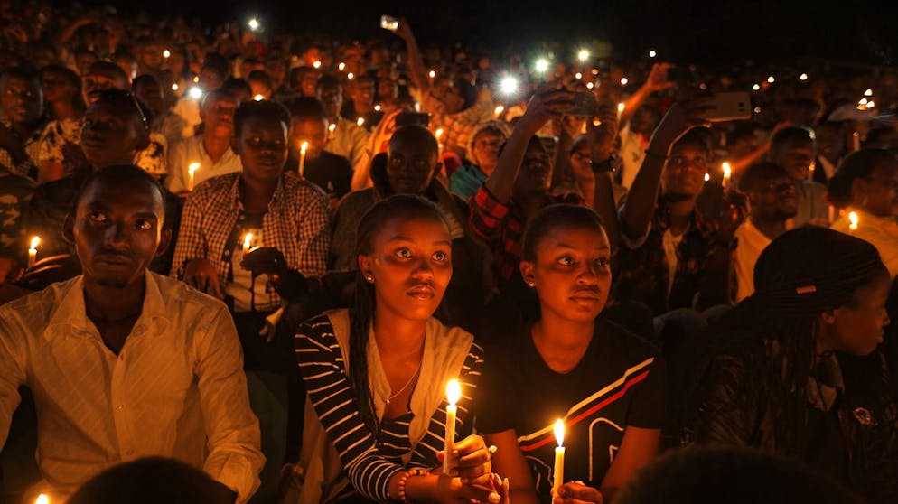 FILE - In this Sunday, April 7, 2019 file photo, people attend a candlelit vigil during a memorial service marking 25 years since the genocide, at Amahoro stadium in the capital Kigali, Rwanda. France's role before and during 1994's Rwandan genocide was a