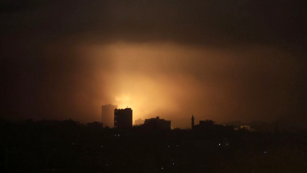 An explosion from an Israeli strike lights up the sky in eastern Gaza City, early Wednesday, July 30, 2014, amid Israel's heaviest air and artillery assault in more than three weeks of Israel-Hamas fighting. (AP Photo/Khalil Hamra)
