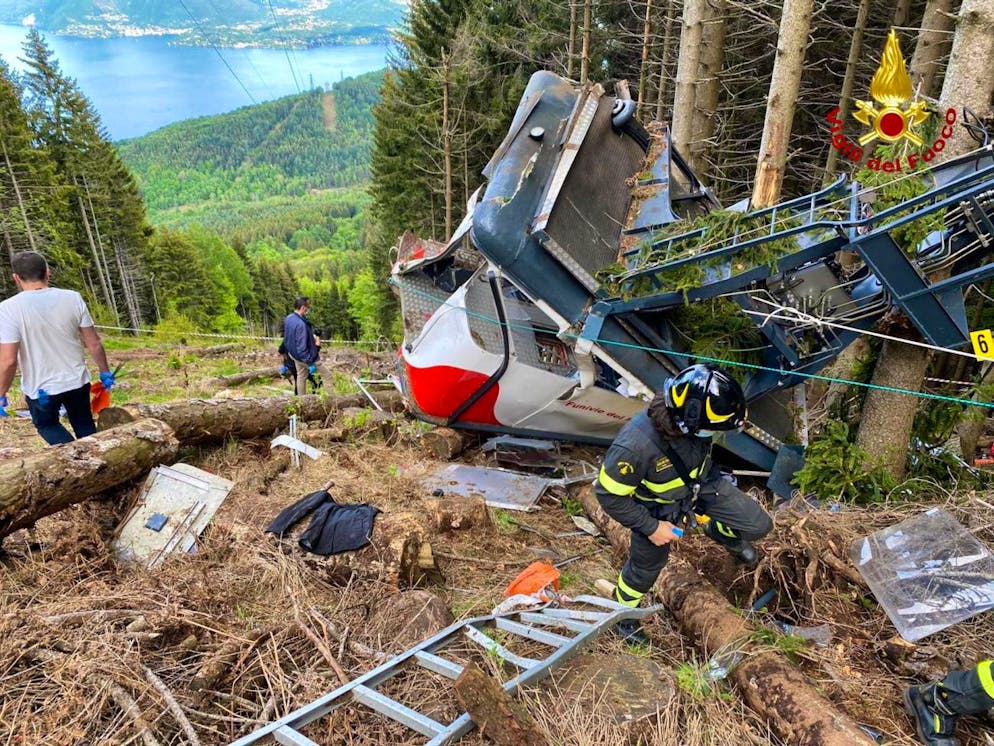 epa09223878 A handout photo made available by Italian Fire and Rescue Service shows Rescuers at work at the area of the cable car accident, near Lake Maggiore, northern Italy, 23 May 2021. The cable car that connects Stresa with Mottarone has crashed, claiming 14 lives, according to the latest toll. The accident has been caused by the failure of a rope, in the highest part of the route which, starting from Lake Maggiore reaches an altitude of 1,491 meters. EPA/ITALIAN FIRE AND RESCUE SERVICE / HANDOUT HANDOUT EDITORIAL USE ONLY/NO SALES