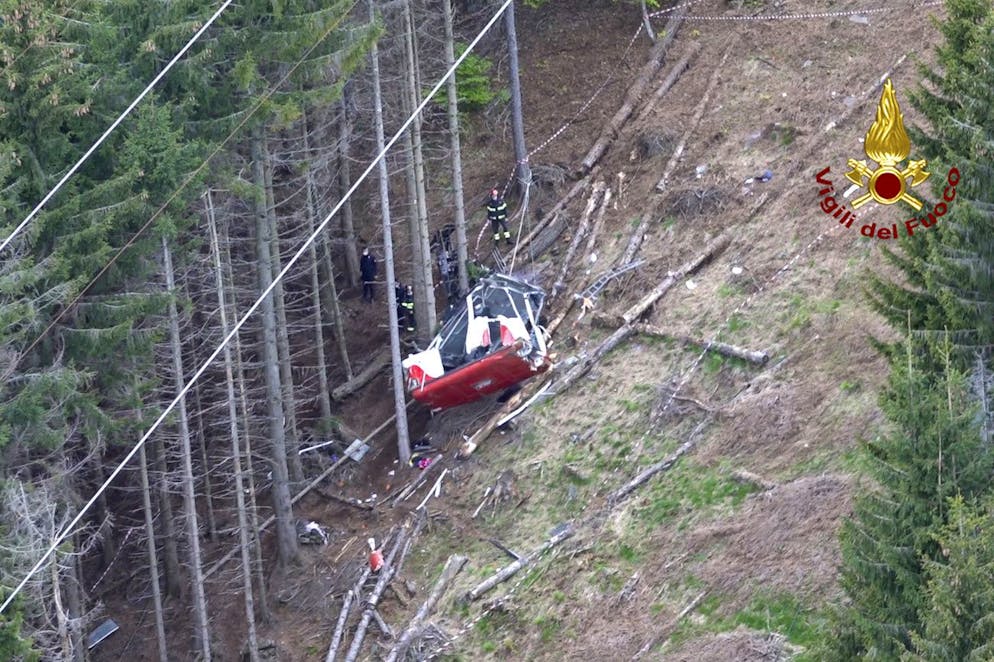 Rescuers work by the wreckage of a cable car after it collapsed near the summit of the Stresa-Mottarone line in the Piedmont region, northern Italy, as seen from the aerial photograph, Sunday, May 23, 2021. ItalyâÄ™s transport minister was heading Monday, May 24, 2021 to the scene of a cable car disaster that killed 14 people when the lead cable apparently snapped and the cabin careened back down the mountain until it pulled off the line and crashed to the ground. (Vigili del Fuoco Firefighters via AP)