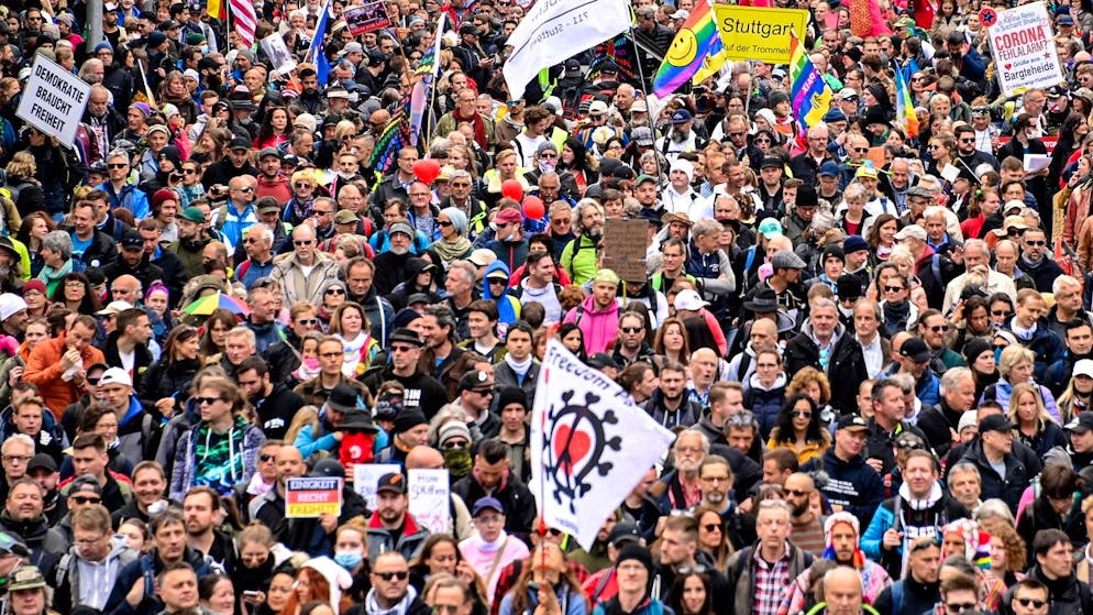 epa09113623 Protesters hold banners during a demonstration held by the ‘Querdenker' (lateral thinkers) movement against the German government's coronavirus restrictions in Stuttgart, Germany, 03 April 2021. Stuttgart is the center of the ‘Querdenker' movement, founded by entrepreneur Michael Ballweg, as the broadest possible grouping against the government's COVID-19 measures. The police is deployed with several hundred units while thousands are protesting. EPA/SASCHA STEINBACH
