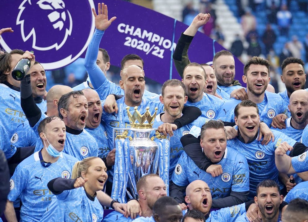 Manchester City's head coach Pep Guardiola, centre, celebrates winning the English Premier League title after the soccer match between Manchester City and Everton at the Etihad stadium in Manchester, Sunday, May 23, 2021.(AP Photo/Dave Thompson, Pool)