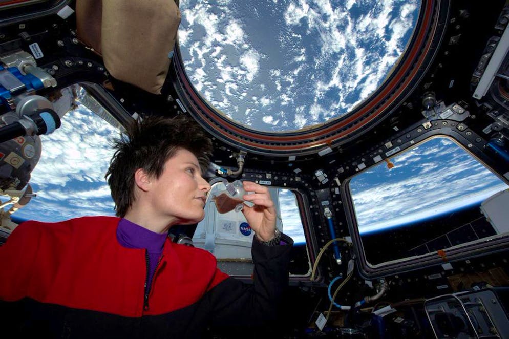 In this photo posted on Twitter, Sunday, May 3, 2015, and provided by NASA, Italian astronaut Samantha Cristoforetti sips espresso from a cup designed for use in zero-gravity, on the International Space Station. Cristoforetti, the first Italian woman in space, fired up the first espresso machine in space, which uses small capsules, or pods, of espresso coffee. (NASA via AP)