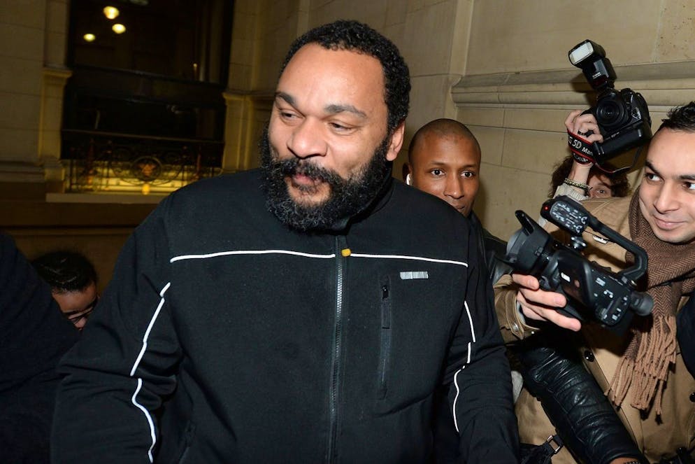 epa04590915 French comedian Dieudonne M'Bala M'Bala, arrives for his trial at the Court House, in Paris, France, 28 January 2015. Controversial comedian Dieudonne M'Bala M'Bala stands trial for a anti-semitic comments about famous jewish radio host in France, Patrick Cohen. Dieudonne has been convicted in the past for anti-Semitic remarks. EPA/CAROLINE BLUMBERG