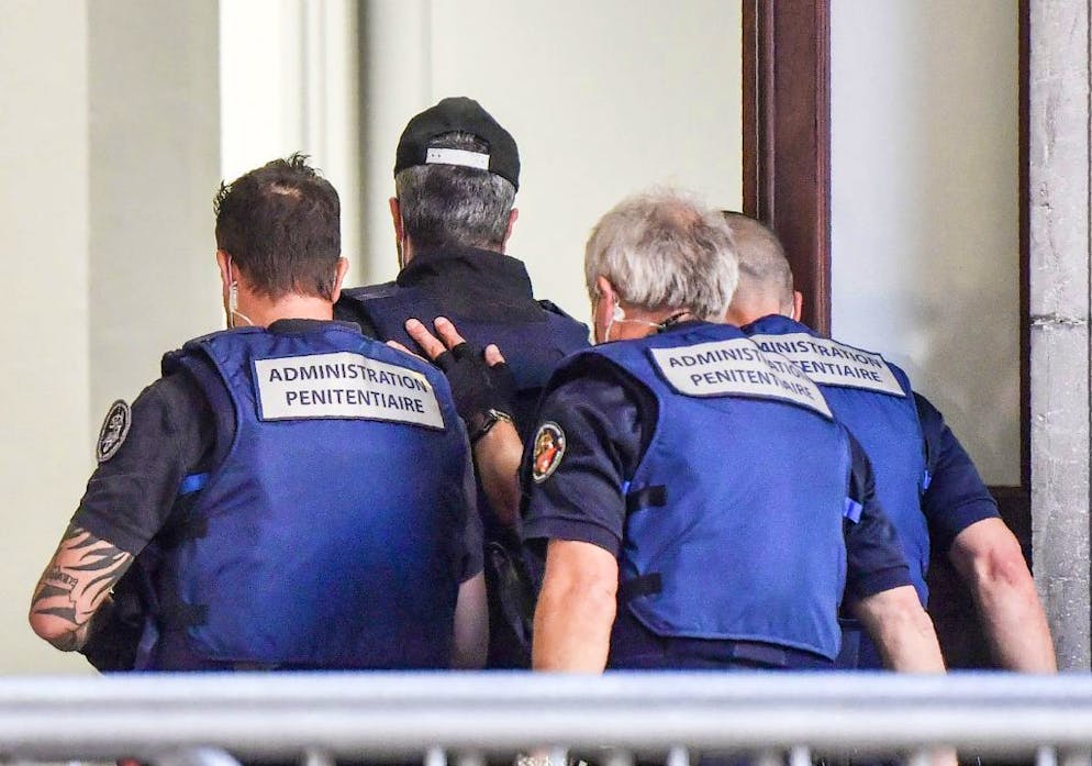 Nordahl Lelandais (C) arrives escorted by French prison administration (administration penitentiaire) officers at the courthouse of the French Alps city of Chambery on May 3, 2021, on the first day of his trial for the murder of French army Corporal Arthur Noyer in 2017. - Nordahl Lelandais, a former military dog trainer, was charged with the murder of Arthur Noyer, a 24-year-old soldier who was last seen in the early hours of April 12, 2017 hitchhiking in the town of Chambery after leaving a nightclub. Lelandais was previously charged for the abduction and murder in August 2017 of an eight-year-old girl named Maelys de Araujo who disappeared from a wedding only a half-hour drive from Chambery. (Photo by PHILIPPE DESMAZES / AFP) (Photo by PHILIPPE DESMAZES/AFP via Getty Images)