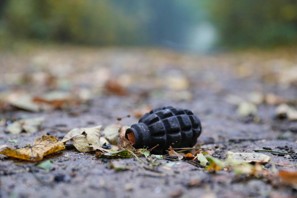 epa07081018 A fragmentation hand grenade shell without fuze lies on a road near an ammunition depot of the Ukrainian Armed Forces near the city of Ichnya, Chernihiv area, Ukraine, 09 October 2018. Munitions including heavy artillery ammunition and 122mm rockets for multiple rocket launchers detonated after a fire broke out at the ammunition depot. Deputy Head of the General Staff of the Armed Forces of Ukraine Rodion Tymoshenko told the media that the fire at the 6th arsenal started with four explosions in a warehouse. EPA/SERGEY DOLZHENKO