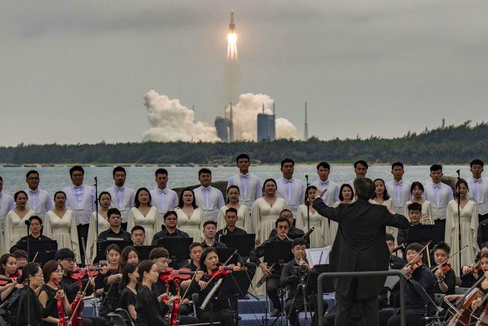 epa09166962 Members of the Xian Symphony Orchestra and Chorus perform during the launch of the Long March 5B rocket (back) carrying China's Tianhe space station core module from the Wenchang Spacecraft Launch Site in Hainan Province, China, 29 April 2021. China launched into space the core module of its space station, marking the beginning of a series of launch missions to complete the space station by the end of next year. (KEYSTONE/EPA/MATJAZ TANCIC)