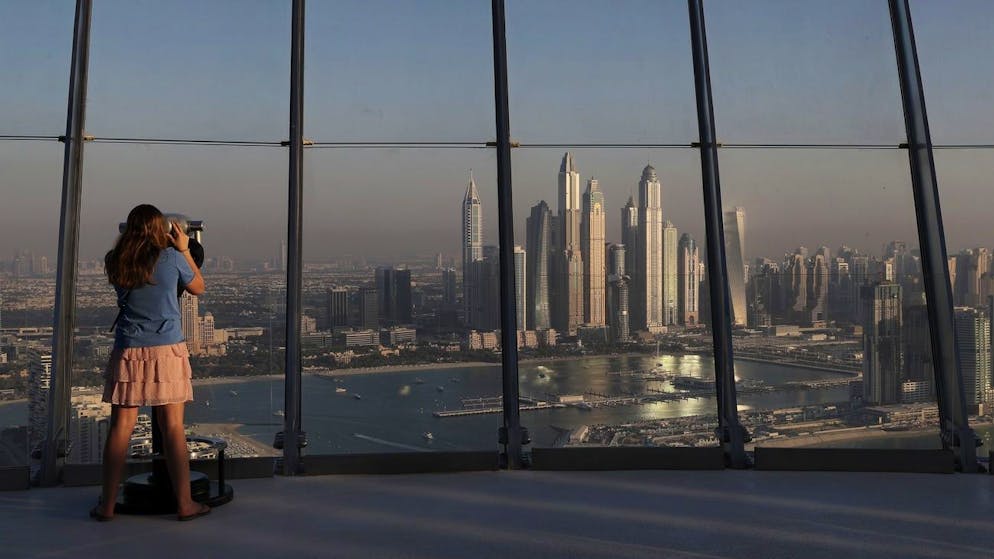 Eine Frau schaut auf die Hochhäuser des Marina-Distrikts in Dubai. (Archivbild)