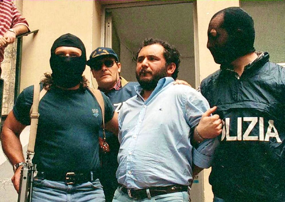 epa09241057 (FILE) - Giovanni Brusca (C) is led off by police following his interrogation in Palermo, Sicily, Italy, 21 May 1996 (issued 01 June 2021). Brusca, 64, was released from Rome's Rebibbia prison on 31 June 2021 after 25 years in jail, having served all but 45 days of his sentence. Brusca was arrested in May 1996 and sentenced to life for over 100 murders, including that of anti-Mafia prosecutor Giovanni Falcone, his wife Francesca Morvillo and three police officers in May 1992. EPA/LANNINO BEST QUALITY AVAILABLE