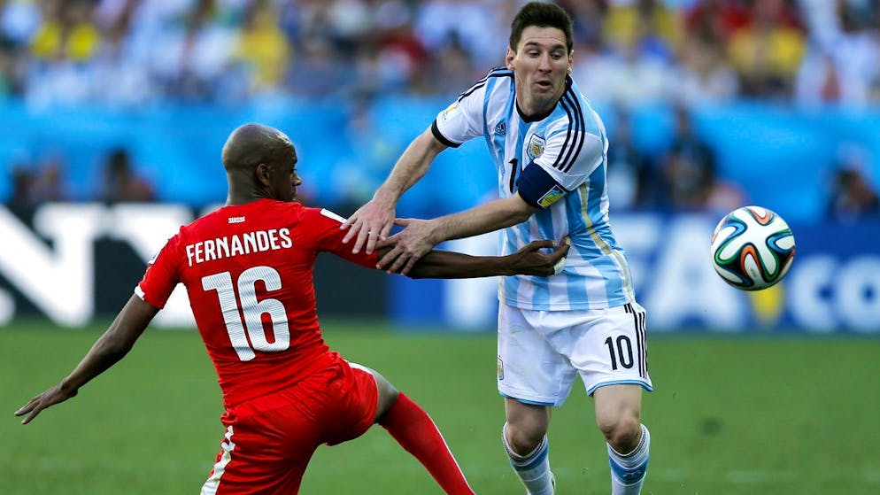 Switzerland's Gelson Fernandes, left, tries to stop Argentina's Lionel Messi during the World Cup round of 16 soccer match between Argentina and Switzerland at the Itaquerao Stadium in Sao Paulo, Brazil, Tuesday, July 1, 2014. (AP Photo/Victor R. Caivano)