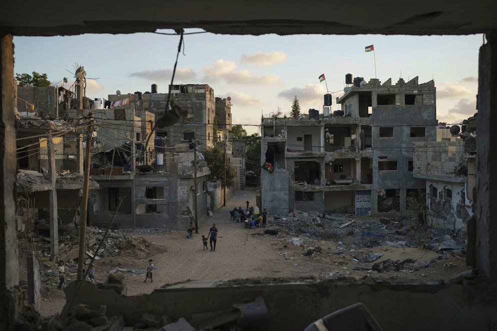 Palestinian flags wave atop buildings heavily damaged by airstrikes during an 11-day war between Gaza's Hamas rulers and Israel, Saturday, June 5, 2021, in Beit Hanoun, Gaza Strip. (AP Photo/Felipe Dana)