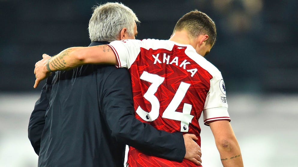 LONDON, ENGLAND - DECEMBER 06: Jose Mourinho, Manager of Tottenham Hotspur embraces Granit Xhaka of Arsenal following the Premier League match between Tottenham Hotspur and Arsenal at Tottenham Hotspur Stadium on December 06, 2020 in London, England. A limited number of fans (2000) are welcomed back to stadiums to watch elite football across England. This was following easing of restrictions on spectators in tiers one and two areas only. (Photo by Glyn Kirk - Pool/Getty Images)