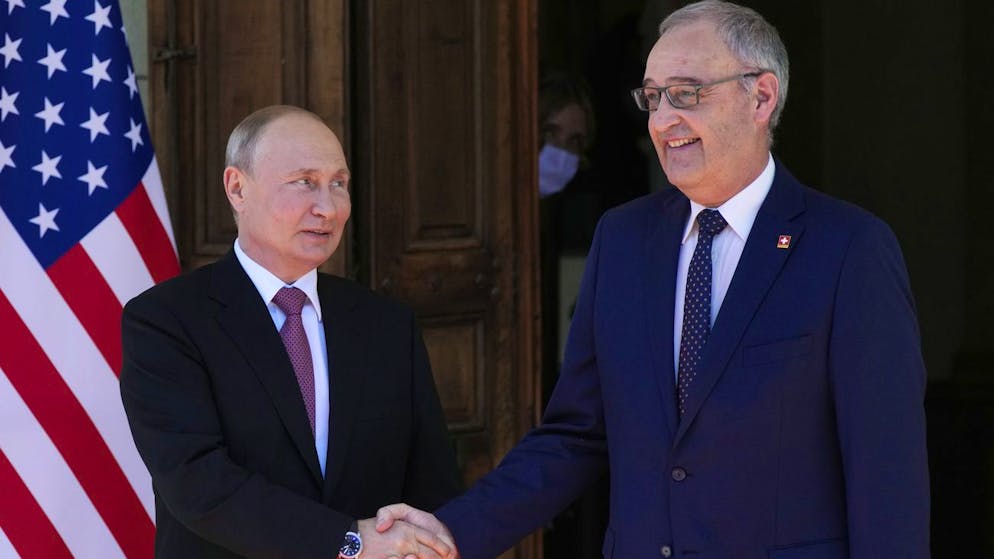 Russian President Vladimir Putin, left, and Swiss President Guy Parmelin shake hands prior U.S President Joe Biden and Russian President Vladimir Putin meeting at the 'Villa la Grange' in Geneva, Switzerland in Geneva, Switzerland, Wednesday, June 16, 2021. (AP Photo/Alexander Zemlianichenko, Pool)