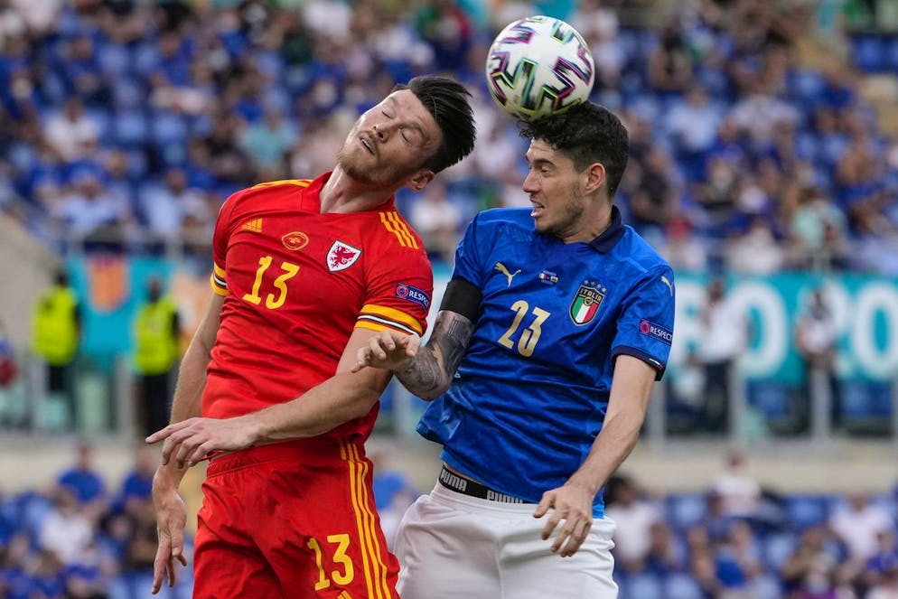 Wales' Kieffer Moore, left, and Italy's Alessandro Bastoni vie for the ball during the Euro 2020 soccer championship group A match between Italy and Wales, at the Rome Olympic stadium, Sunday, June 20, 2021. (AP Photo/Alessandra Tarantino, Pool via AP)