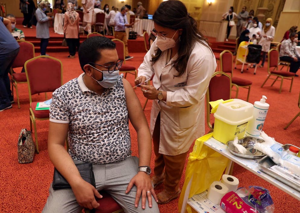 epa09247307 A Tunisian working in the tourism industry receives a dose of the Pfizer-BioNTech vaccine against COVID-19 during the vaccination campaign for tourism professionals in Tunis, Tunisia, 04 June 2021. According to Tunisian Tourism Minister Habib Ammar, 'Seven vaccination centers spread over different regions have been set up to ensure this operation, which aims to protect the employees of the sector as well as their families'. EPA/MOHAMED MESSARA