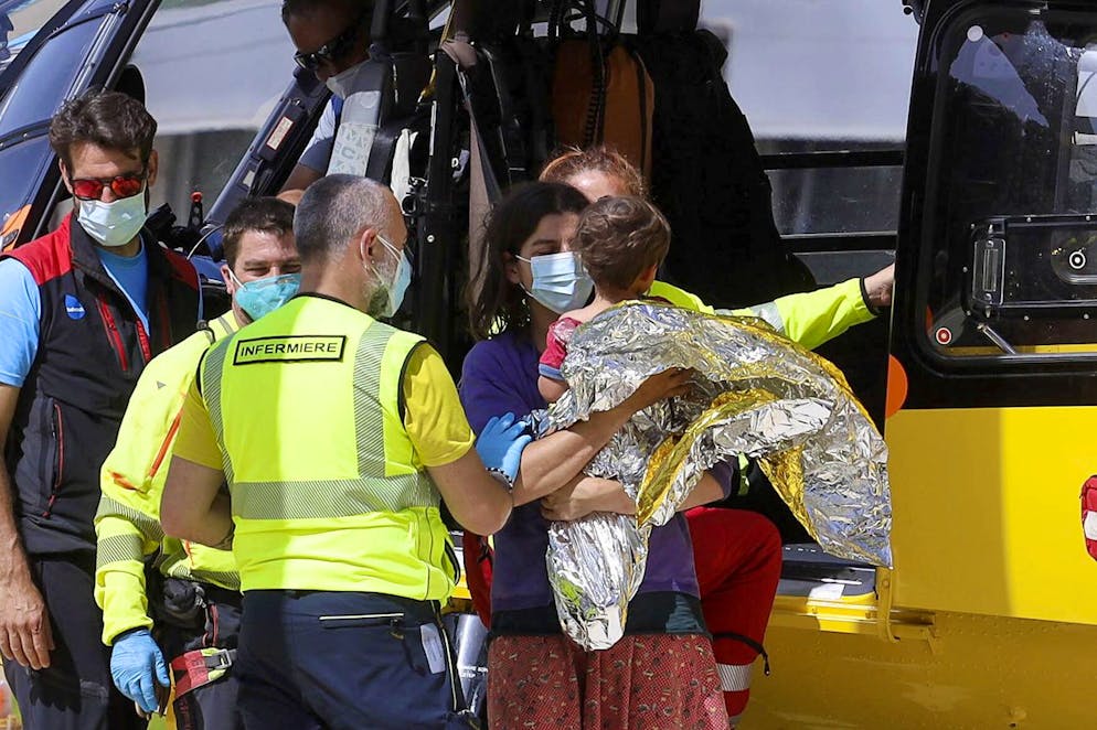 21-month-old Nicola Tanturli is carried by his mother after they were transported by helicopter to Careggi hospital in Florence, Italy, Wednesday, June 23, 2021. The child was found alive Wednesday in the bottom of a ravine after spending two nights alone in the woods near his home in Tuscany. ( Giuseppe CabrasLaPresse via AP)