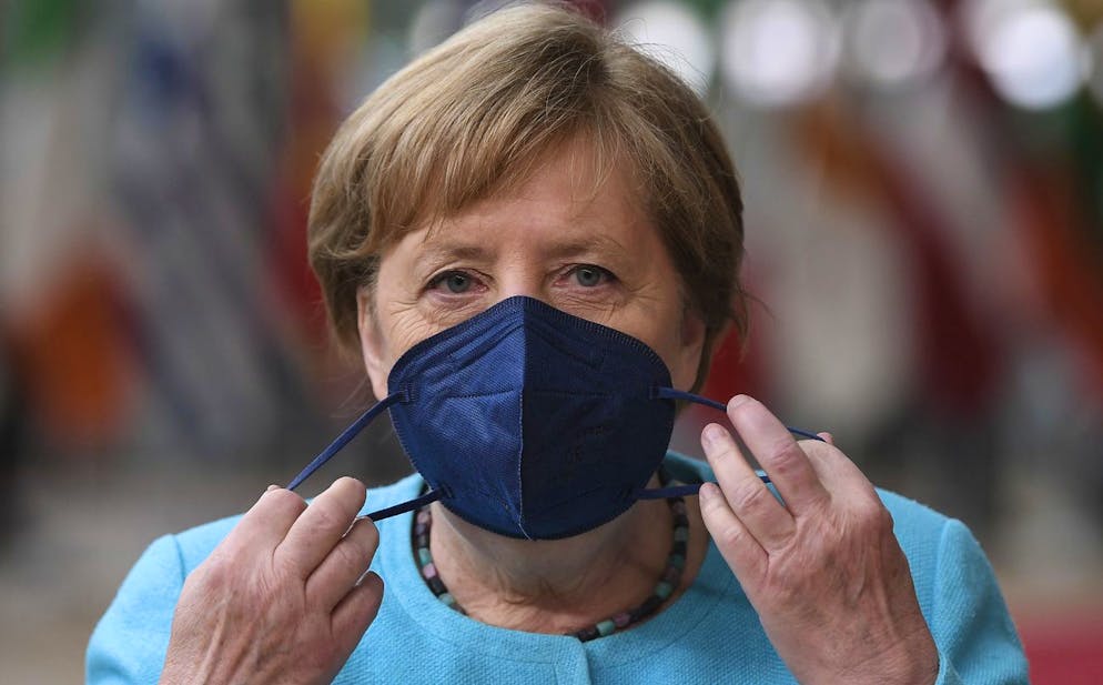 Germany's Chancellor Angela Merkel removes her protective face mask as she arrives for an EU summit at the European Council building in Brussels, Thursday, June 24, 2021. At their summit in Brussels, EU leaders are set to take stock of coronavirus recovery plans, study ways to improve relations with Russia and Turkey, and insist on the need to develop migration partners with the countries of northern Africa, but a heated exchange over a new LGBT bill in Hungary is also likely. (John Thys, Pool Photo via AP)