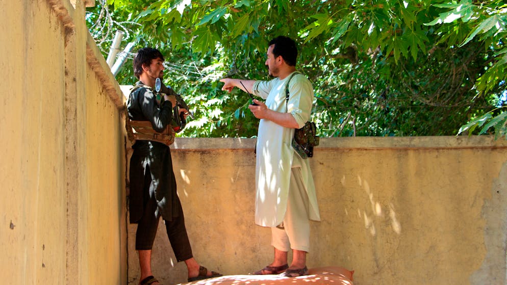 Afghan security personnel stand behind a wall during fighting between Taliban and Afghan security forces in Kunduz city, north of Kabul, Afghanistan, Thursday, June 24, 2021. Taliban gains in north Afghanistan, the traditional stronghold of the country's minority ethnic groups who drove the insurgent force from power nearly 20 years ago, has driven a worried government to resurrect militias whose histories have been characterized by chaos and widespread killing. (AP Photo/Samiullah Quraishi)