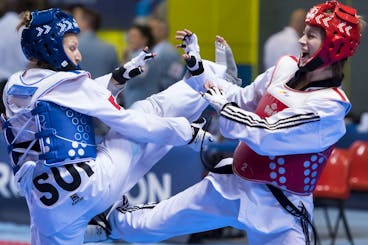 Manuela Bezzola of Switzerland, left, fights against Zeliha Agris of Turkey, right, during the quarter final of the Seniors Female A - 53kg at the European Taekwondo Championships in Montreux, Switzerland, Friday, May 20, 2016. (KEYSTONE/Jean-Christophe Bott)