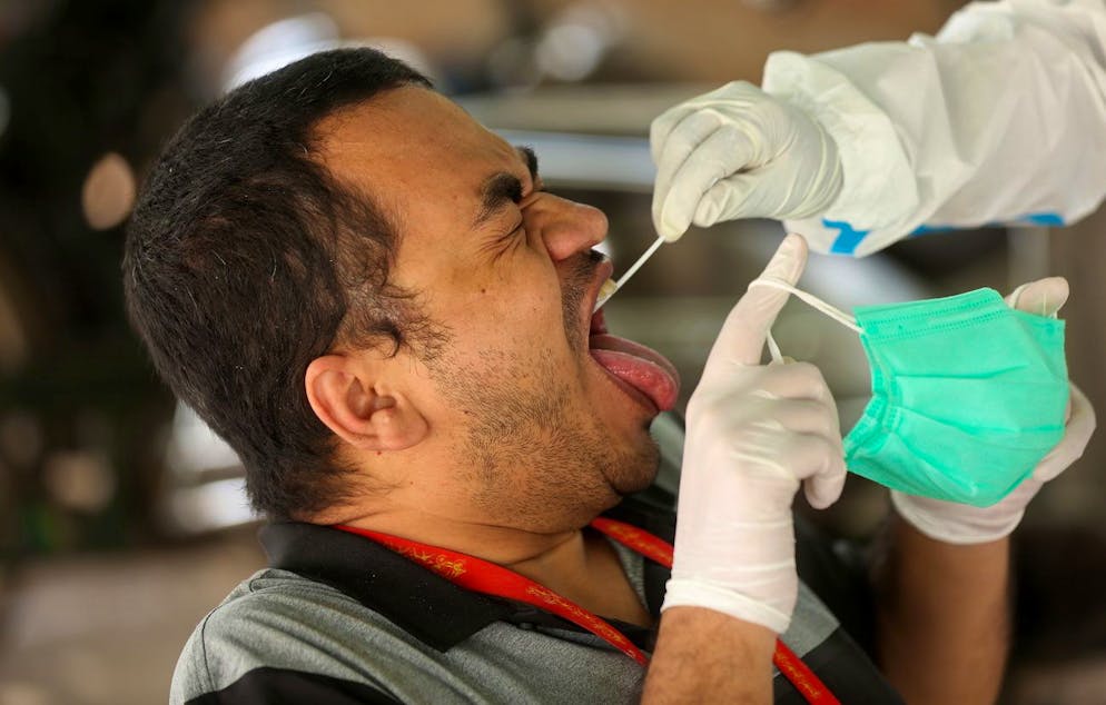 epa09255048 Indian health worker takes a swab and nasal sample of a man for COVID-19 test in Bangalore, India, 08 June 2021. India reported 86,498 new Covid-19 cases and 2,115 coronavirus COVID19 deaths in the last 24 hours, the lowest spike of daily cases in 66 days. EPA/JAGADEESH NV