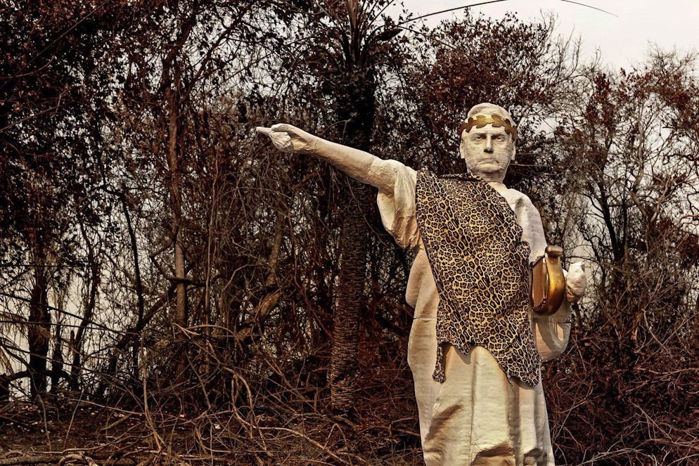 epa08732919 A handout photo made available by the environmental organization Greenpeace Brazil that shows a statue of Brazilian President Jair Bolsonaro depicted as Roman Emperor Nero in the middle of an area devastated by forest fires in El Pantanal, Brazil (issued 09 October 2020). EPA/GREENPEACE BRAZIL HANDOUT MANDATORY CREDIT: GREENPEACE BRAZIL HANDOUT EDITORIAL USE ONLY/NO SALES