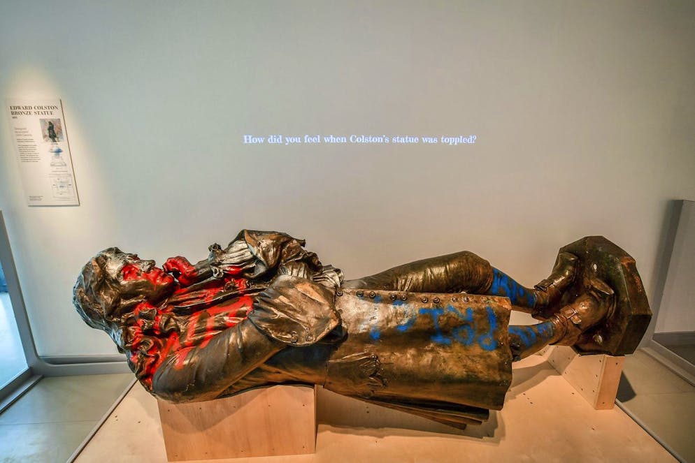 A view of the statue of slave trader Edward Colston, which was toppled during a protest on June 7, 2020 on display at the M Shed as part of the preview of 'The Colston statue: What next?', in Bristol, England, Thursday June 3, 2021. A statue of a 17th-century slave trader that was toppled during anti-racism protests in the English city of Bristol is being displayed in a museum, with visitors being asked to help decide its fate. The bronze likeness of Edward Colston was pulled from its pedestal and dumped in Bristol harbor a year ago, sparking a nationwide debate about commemoration and BritainâÄ™s slave-trading history. City workers hauled the statue out of the water and have kept it in storage ever since. (Ben Birchall/PA via AP)